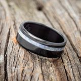 a black and white ring sitting on top of a wooden table