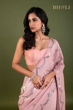 Expertly crafted with high quality Georgette fabric, this partywear saree is designed to make a statement. The elegant pink color and delicate sequin embellishments add a touch of glam to any occasion. Shine bright while feeling comfortable and confident in this must-have saree. Festive Pre-draped Sequined Dola Silk Saree, Party Wear Pre-draped Saree With Unstitched Blouse, Diwali Party Pre-draped Tissue Silk Saree, Sequin Pre-draped Chinon Saree, Party Wear Pre-draped Saree With Cutdana, Festive Pink Pre-draped Dola Silk Saree, Designer Pink Pre-draped Saree With Zari Work, Pink Pre-draped Tissue Silk Saree With Unstitched Blouse, Pink Tissue Silk Pre-draped Saree With Unstitched Blouse