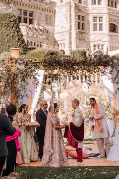 a couple getting married in front of an ornate building