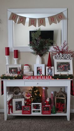 a christmas mantle with pictures and decorations on it