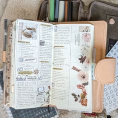 an open planner book sitting on top of a carpet next to other items and papers