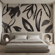 a large bed sitting in a bedroom next to a wall with black leaves on it