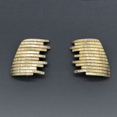 - Presented is a stylish pair of vermeil (gold plated sterling silver) earrings. These contemporary earrings are made in an elegant ridged and textured design that catches the light beautifully. The earrings have clip on style backs, suitable for wear with unpierced or pierced ears.  This pair of earrings is in excellent condition. The gold wash is in great shape. The clipbacks have a good strong spring mechanism.   The earrings are nitric acid tested and guaranteed sterling silver.   Each earri Elegant Textured Formal Earrings, Contemporary Hammered Gold Earrings, Contemporary Gold Hammered Earrings, Modern Textured Gold Earrings, Elegant Textured Gold Plated Earrings, Modern Gold Clip-on Earrings For Anniversary, Spring Mechanism, Contemporary Earrings, Gold Wash