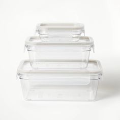 three plastic containers with lids stacked on top of each other in front of a white background