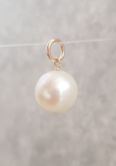 Beautiful  white freshwater pearl for you to put on your own necklace or bracelet.  Approximately 12mm near round pearl has a nice creamy white lustre, It has a 6mm ring bail with the inside diameter measuring approx 5mm. All the metal parts including the jump ring are gold filled. The overall length of the pearl charm / pendant, measuring from the top of the ring is approx. 2cm. The pearl in the photos is the actual pearl you will receive. I use pearls are genuine freshwater pearls therefore ea White Freshwater Pearl, Pearl Charms, Necklace Chain, White Pearl, Jump Rings, Pearl Pendant, Pearl White, Charm Pendant, Chains Necklace