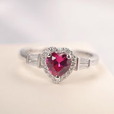 All HANDMADE ITEMS SHIP IN APPROX 8 DAYS Main Stone: Lab created ruby Main Stone Size: Heart cut 6 mm x 6mm Main Stone Weight: 1.16 carat Side Stone: CZs Height From The Ring Setting Bottom(to gemstone top): about 5.25 mm Width of Ring band Measure: gradually varied,about 2.08 to 2.31 mm Material: .925 Sterling Silver/14K White Gold/14K Yellow Gold/14k Rose Gold Engraved: Available For FreeNo more than 13 letters) Customized:Of course! Tell me what you want Includes With Order: All of my store i Valentine's Day Anniversary Ruby Ring, Fine Jewelry Rings With Brilliant Cut For Valentine's Day, Gift Lab-created Ruby Birthstone Ring With Center Stone, Valentine's Day Round Ruby Ring With Brilliant Cut, Elegant Red Heart-shaped Diamond Ring, Valentine's Day Ruby Ring With Accent Stones, Valentine's Day Anniversary Diamond Ring With Halo Setting, Gift Lab-created Ruby Birthstone Ring, Valentine's Day Fine Jewelry Rings With Brilliant Cut