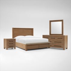 a bedroom with a bed, dresser and mirror on the wall next to each other