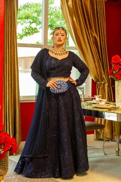 Adorned with intricate self-sequins, this deep blue masterpiece is sure to dazzle in the Adhara Lehenga. The look is completed with a full-sleeve blouse and a net dupatta that has been embellished with sparkling details. Pure luxury awaits in the Adhara Lehenga, an incredible work of art in a deep blue hue with intricate self-sequins that will leave you mesmerized. Team it up with an intricately designed full-sleeve blouse paired with a net dupatta embellished with sparkly details for the fashio Anarkali Style Embellished Lehenga For Formal Occasions, Formal Anarkali Lehenga Embellished, Formal Embellished Anarkali Lehenga, Evening Dupatta With Intricate Embroidery, Festive Dupatta With Intricate Embroidery For Evenings, Festive Evening Dupatta With Intricate Embroidery, Anarkali Blouse Piece With Dupatta For Evening, Evening Georgette Dupatta With Intricate Embroidery, Blue Sequined Party Wear Choli