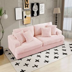 a pink couch sitting on top of a white rug