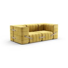 a yellow couch sitting on top of a white floor next to two boxes with silver handles