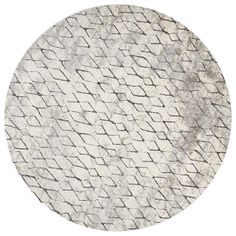 a round rug with white and gray patterns