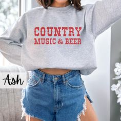 Country Music and Beer Sweatshirt, Beer Shirt, Country Sweatshirt, Western Crewneck, Country Music, Rodeo Shirt, Cowgirl Sweatshirt, Cowboy, Drinking Sweater, Trendy Sweatshirt, Graphic Sweatshirt -Gildan 18000 Crewneck Sweatshirts -Unisex Adult Sizing -Props used in photos are NOT included -Different colors are available for different designs -50% cotton, 50% polyester -Medium-heavy fabric (8.0 oz/yd² (271.25 g/m -Loose fit -Sewn-in label -Runs true to size PRINT: -Direct to garment -The design Music-themed Slogan Crew Neck Top, Music-themed Slogan Tops With Crew Neck, Music-themed Slogan Top With Crew Neck, Fall Music-themed Cotton Tops, Relaxed Fit Music-themed Crew Neck Top, Music-themed Cotton Crew Neck Sweatshirt, Cotton Letter Print Sweatshirt For Concert, Music-themed Cotton Sweatshirt With Letter Print, Music-themed Cotton Crew Neck Top