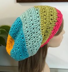 "Made with acrylic wool blend yarn, hand wash lay flat to dry. Measures 11\" across and 13\" deep. Wear your hair tucked in or just slouch it. Will hold long hair or dreads. Comes with a drawstring and lock. A mixture of bright colors and done in and X stitch pattern." Multicolor Slouchy Bohemian Crochet Hat, Multicolor Slouchy Crochet Hat, Slouchy Multicolor Handmade Crochet Hat, Multicolor Crochet Slouchy Hat, Multicolor Beanie For Beach, One Size Fits Most, Handmade Multicolor Slouchy Hat, Slouchy Multicolor Beanie Hat, Purple Shawl, Hair Tuck