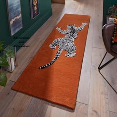 an orange area rug with a drawing of a woman on it in the middle of a living room