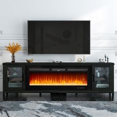 an entertainment center with a fireplace in the middle and a flat screen tv above it