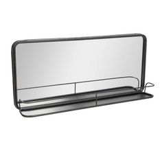 a large mirror sitting on top of a metal shelf