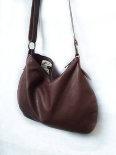 Leather mini hobo bag made with brown soft leather. The bag is closed with a metallic zip. Inside is unlined and there is a large cotton zipped pocket. There is an adjustable shoulder strap made with stronger brown leather. Features : - Brown leather, - Zipped bag, - Unlined, - Inside cotton zipped pocket, Size: - Height 10 inch, - Lenght 14 inch, - Shoulder belt is adjustable. Contact me for any information --------------------------------------- The shipping is made after 3 days by the purchas Leather Hobo Bag With Zipper Closure, Leather Hobo Bag With Zipper Pocket For Everyday, Brown Crossbody Hobo Bag With Removable Pouch, Brown Leather Lined Satchel Hobo Bag, Brown Leather Shoulder Hobo Bag, Brown Leather-lined Satchel Hobo Bag, Brown Leather Crossbody Hobo Bag, Leather Brown Hobo Bag With Zipper Pocket, Brown Leather Hobo Bag With Zipper Pocket