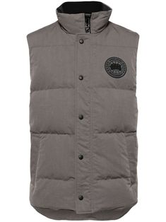 grey cotton blend duck down logo patch at the chest padded design high neck front press-stud and zip fastening sleeveless rear curved hem Gray Sleeveless Vest For Outdoors, Gray Sleeveless Vest For Outdoor, Sleeveless Cotton Puffer Outerwear, Cotton Puffer Vest, Casual Cotton Puffer Vest, Casual Cotton Vest With Padded Collar, Sporty Cotton Vest For Winter, Casual Streetwear Vest With Padded Collar, Nylon Vest With Padded Collar For Streetwear