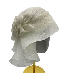 TIMELESS BEAUTY EXUDES AN AURA OF BLISS AROUND YOU Couture hat with bow and brooch Kentucky Derby Wedding headwear This beautiful women's couture hat with golden trim&brooch looks amazingly stunning and ideally accessorizes a multitude of your apparel. Whether you choose a classical dress or a modern and stylish outfit for the upcoming event, this cloche will surely bring out the magnetism and charisma you are looking for. Created using high-quality handwoven sinamay fiber which is so lightweigh Beige Cloche Hat For Wedding, Elegant Formal Hat With Bow, Gatsby Style Wedding Fascinator With Short Brim, Elegant Hat With Bow For Royal Ascot, Elegant Bow Hat For Royal Ascot, Adjustable Cloche Fascinator, Elegant Mini Hat With Bow For Kentucky Derby, Wedding Hats With Bow And Short Brim, Chic Hat-style Headpiece