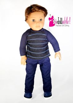 the doll is wearing blue pants and a black shirt with stripes on it's chest