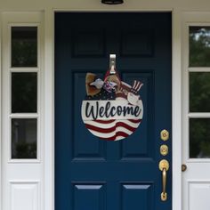 a blue door with an american flag welcome sign on it's front and side