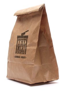 a brown paper bag sitting on top of a white table