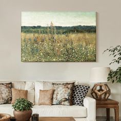 a living room filled with furniture and a painting on the wall above it's coffee table