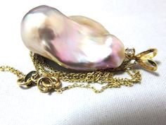 This necklace is  18-1/2" long (chain length). Pendant (1-9/16" high) - Natural 1-1/4" x 7/8" jumbo size purple and pink rainbow fireball high luster pearl. 18K solid yellow gold pearl mounting with natural diamond setting, 14K solid yellow gold chain, solid white gold not gold filled not gold plated. Wire work. Holiday gift. High Fashion. Handmade, beautiful, gorgeous and special design. Yellow Gold Pear-shaped Pearl Necklace With High Luster, Yellow Gold Pear-shaped High Luster Pearl Necklace, Pear-shaped High Luster Yellow Gold Pearl Necklace, Pink Rainbow, Yellow Gold Setting, Diamond Settings, Yellow Gold Chain, Wire Work, Long Chain