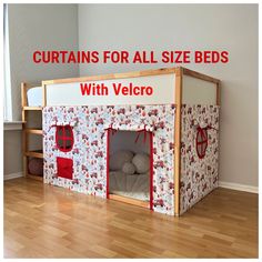 a child's bed with a red and white tent on the bottom, next to a wooden floor