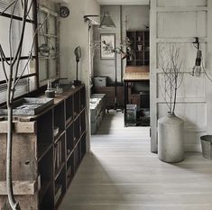 an old fashioned kitchen with white walls and wood flooring is shown in black and white