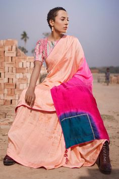 Peach georgette saree with all over pink, sea green color block pattern on pallu and aari hand work highlights. Paired with round neck silk blouse with all over traditional textiles woven stripe pattern.
Components: 2
Pattern: Hand Embroidered and Woven
Type Of Work: Stripe Pattern and Aari Work
Neckline: Round Neck
Sleeve Type: Half Sleeves
Fabric: Silk, Georgette
Color: Peach
Other Details: 
Drop tasselled pallu edges
Contrast piping details
Occasion: Sangeet - Aza Fashions Fusion Style Pre-draped Saree For Festivals With Unstitched Blouse, Pink Raw Silk Pre-draped Saree With Dupatta, Pink Silk Pre-draped Saree With Cutdana, Fusion Style Unstitched Blouse Piece For Festive Occasions, Pink Georgette Blouse With Sheer Dupatta, Pink Anarkali Style Silk Pre-draped Saree, Transitional Pink Raw Silk Pre-draped Saree, Peach Semi-stitched Saree For Navratri, Pink Tissue Silk Pre-draped Saree With Unstitched Blouse