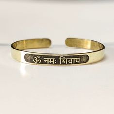 "Om Namah Shivay Sacred Bracelets, Mantra Bracelet \"Aum Namah Shivaya \"Open Face Cuff Bangle, Sacred Bracelets for Spiritual Bliss, Yoga Gifts You can buy gifts for your loved ones with a personalized bangle.  It will be a unique experience for your Loved one. All of the products are made of sterling silver & brass. We can also make 14k gold upon request. ►HOW TO ORDER 1- Please select your preferred bracelet size from the variations. 2- Please select your preferred metal from the variations. 3- Please write your preferred name you want at the ''Add your personalization'' box for inside marking at checkout. (To avoid mistakes, please write as in the example shown below.) ►PRODUCT DETAILS The material is Solid Sterling Silver, 14k solid gold & Brass. This beautiful bangle comes with a spe Adjustable Bracelets For Meditation And Festivals, Adjustable Spiritual Bracelets For Festivals, Adjustable Spiritual Bracelets For Rituals, Handmade Adjustable Spiritual Bangle, Adjustable Symbolic Bangle Bracelet, Adjustable Bangle For Rituals, Handmade Spiritual Cuff Bracelet For Festivals, Spiritual Festival Bangle Cuff Bracelet, Adjustable Brass Bracelets For Rituals