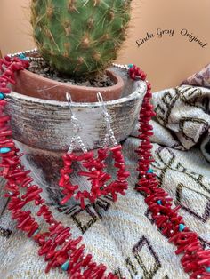 This natural red coral necklace is handmade by me.  The outer strand of red coral has sterling silver spacer beads and the inner strand has turquoise chips for its spacer beads.  It is a 24 inch necklace with a beautiful sterling silver clasp.  A turquoise stone pendant and matching coral earrings are included with purchase.   The earrings are also natural red coral and sterling silver.    Visit MyStylCraft` for a unique shopping experience!  Thanks, Linda Gray Red Southwestern Style Jewelry Gift, Southwestern Style Red Jewelry For Gifts, Southwestern Style Red Jewelry For Gift, Handmade Southwestern Red Jewelry, Artisan Red Coral Hand-strung Jewelry, Southwestern Red Jewelry With Natural Stones, Artisan Hand-strung Red Coral Jewelry, Handmade Turquoise And Red Coral Necklace As Gift, Handmade Turquoise Necklace With Red Coral For Gift