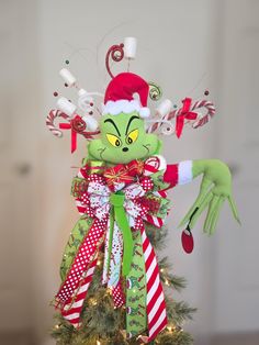 a christmas tree decorated with an elf's head and candy canes