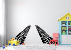 a child's room with a train track wall decal