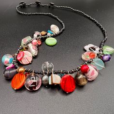 "Awesome handmade boho chic/artsy glass bead necklace has such unique beads, most of which have inner floral glass beads! Just so beautiful; looks like candy. Strung on twisted cord, this lovely necklaces measure 25\" and can be adjusted to 24 or 23\".  Excellent vintage condition." Colorful Beaded Necklace Of Recycled Glass For Gifts, Handmade Czech Glass Beads, Vintage Style, Colorful Recycled Glass Beaded Necklace As Gift, Handmade Vintage Czech Glass Beads, Bohemian Czech Glass Beads With Large Beads, Colorful Recycled Glass Beads Necklace For Jewelry Making, Colorful Beads Necklace For Jewelry Making, Whimsical Czech Glass Beaded Necklace, Bohemian Czech Glass Large Beads