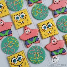 decorated cookies are arranged on a table for a birthday or other celebration, including spongebob and friends