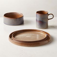 two brown and white dishes sitting next to each other