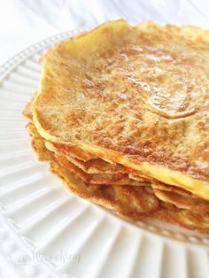 a stack of pancakes sitting on top of a white plate