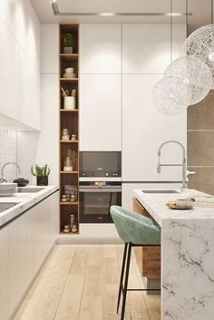 a modern kitchen with marble counter tops and white cabinets, along with wooden flooring