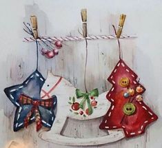 three christmas ornaments are hanging on clothes pins