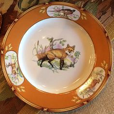 a plate with an image of a fox on it and other plates in the background