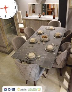 a dining room table is set with plates and silverware