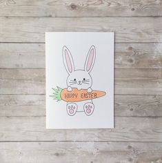 a card with an image of a bunny holding a carrot on it's chest