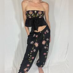 Extra Small Free People Black Flower Embroidered Matching Set - Strapless Crop Top And Comfortable Loose Fit Pants, Never Worn Spring Black Embroidered Pants, Fitted Floral Embroidered Pants For Summer, Fitted Floral Embroidered Summer Pants, Spring Embroidered Black Pants, Black Festival Pants For Spring, Black Pants For Spring Festival, Black Floral Embroidered Bottoms For Summer, Black Bottoms With Floral Embroidery For Summer, Floral Embroidered Bottoms For Spring Festival