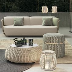 a living room filled with lots of furniture next to each other on top of a rug