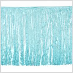 an aqua colored background with fringes on it