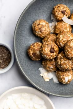 a bowl filled with oatmeal energy bites next to bowls of yogurt