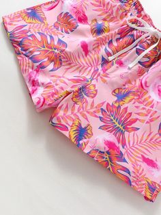 Escape to paradise with these Tropical Print Swim Trunks. The vibrant all-over print and drawstring waist make them a stylish choice for your beach adventures. Stay comfortable with the convenient pocket and non-stretch polyester fabric. Dive into summer in style! Specification: Pattern Type: Tropical, All Over Print Details: Drawstring, Pocket Type: Bottoms Bottom Type: Shorts Fabric: Non-Stretch Material: Polyester Composition: 100% Polyester Care Instructions: Machine wash, do not dry clean, Tropical Swimwear For Summer Activities, Casual Multicolor Swimwear For Summer Activities, Beachy Swimwear With Drawstring For Beach Season, Vacation Swim Trunks With Drawstring For Poolside, Drawstring Swimwear For Poolside Vacation, Poolside Drawstring Swimwear For Vacation, Poolside Vacation Swimwear With Drawstring, Tropical Swim Trunks With Elastic Waistband, Tropical Style Short Swim Trunks With Elastic Waistband