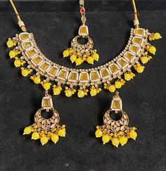 Make a statement with this exquisite jewellery set from Harkirt trade. The beautifully crafted round neck necklace set features stunning stone work in a gold colour. Made in India, this piece is a true reflection of fine craftsmanship and attention to detail. Perfect for any occasion, this jewellery set will elevate any outfit and add a touch of glamour to your look. Ideal for those who appreciate quality and sophistication, this necklace set is a must-have addition to any jewellery collection. Kundan Necklaces With Stones, Kundan Necklaces With Round Stones, Round Kundan Stone Necklaces, Festive Necklaces With Stone Setting, Round Kundan Necklaces With Stones, Traditional Round Kundan Necklace With Stones, Festival Jewelry With Stone Setting For Celebrations, Heavy Round Bollywood Necklaces, Chandbali Jewelry With Stone Setting As Gift